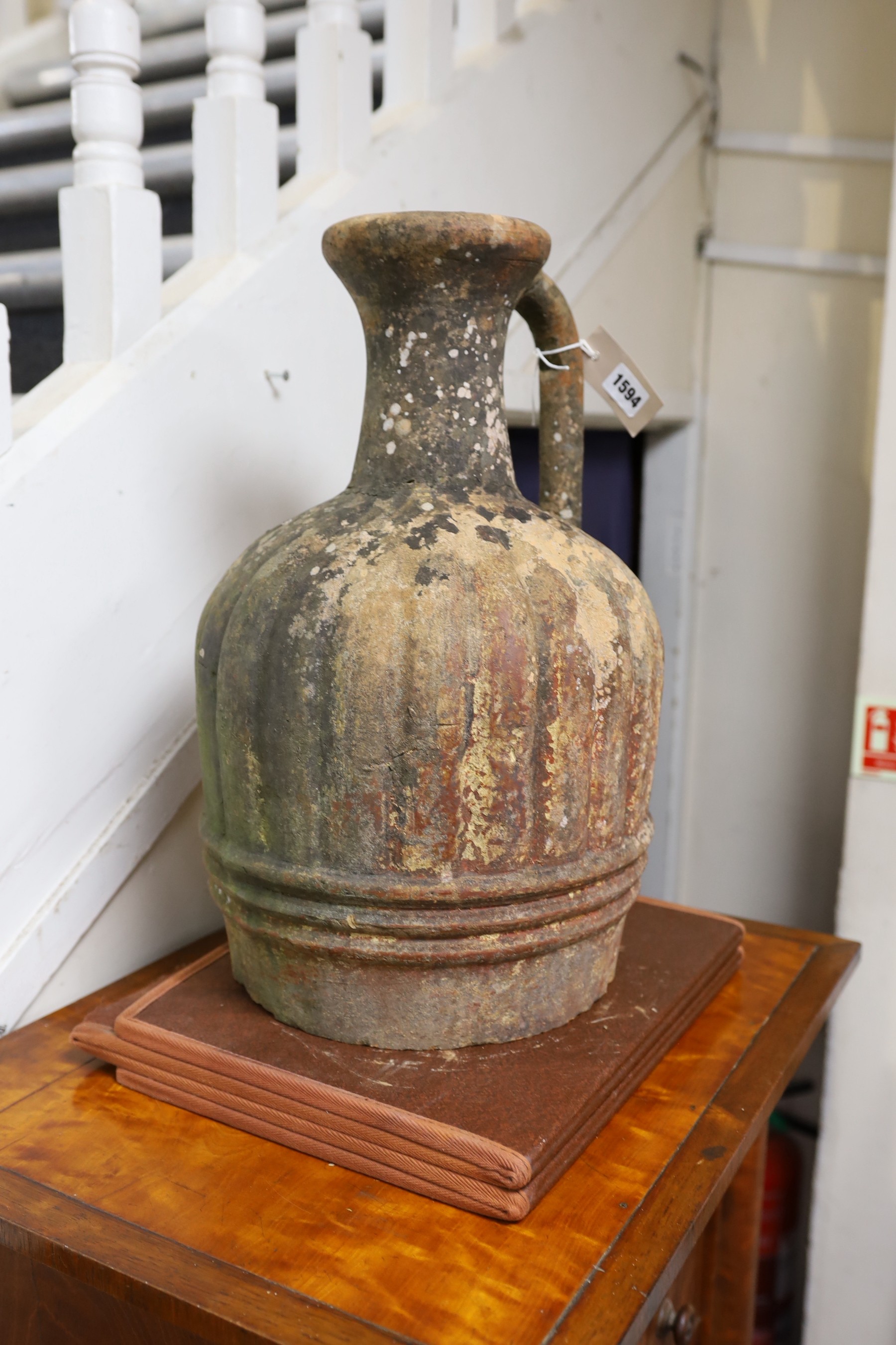 A large Mediterranean terracotta ewer, lacking base, 47cm